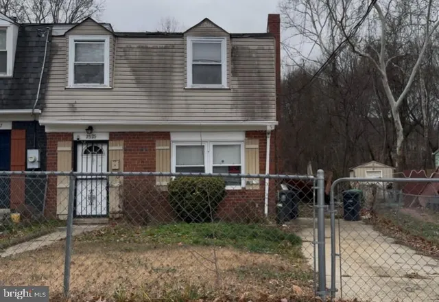 a view of a house with backyard and chairs