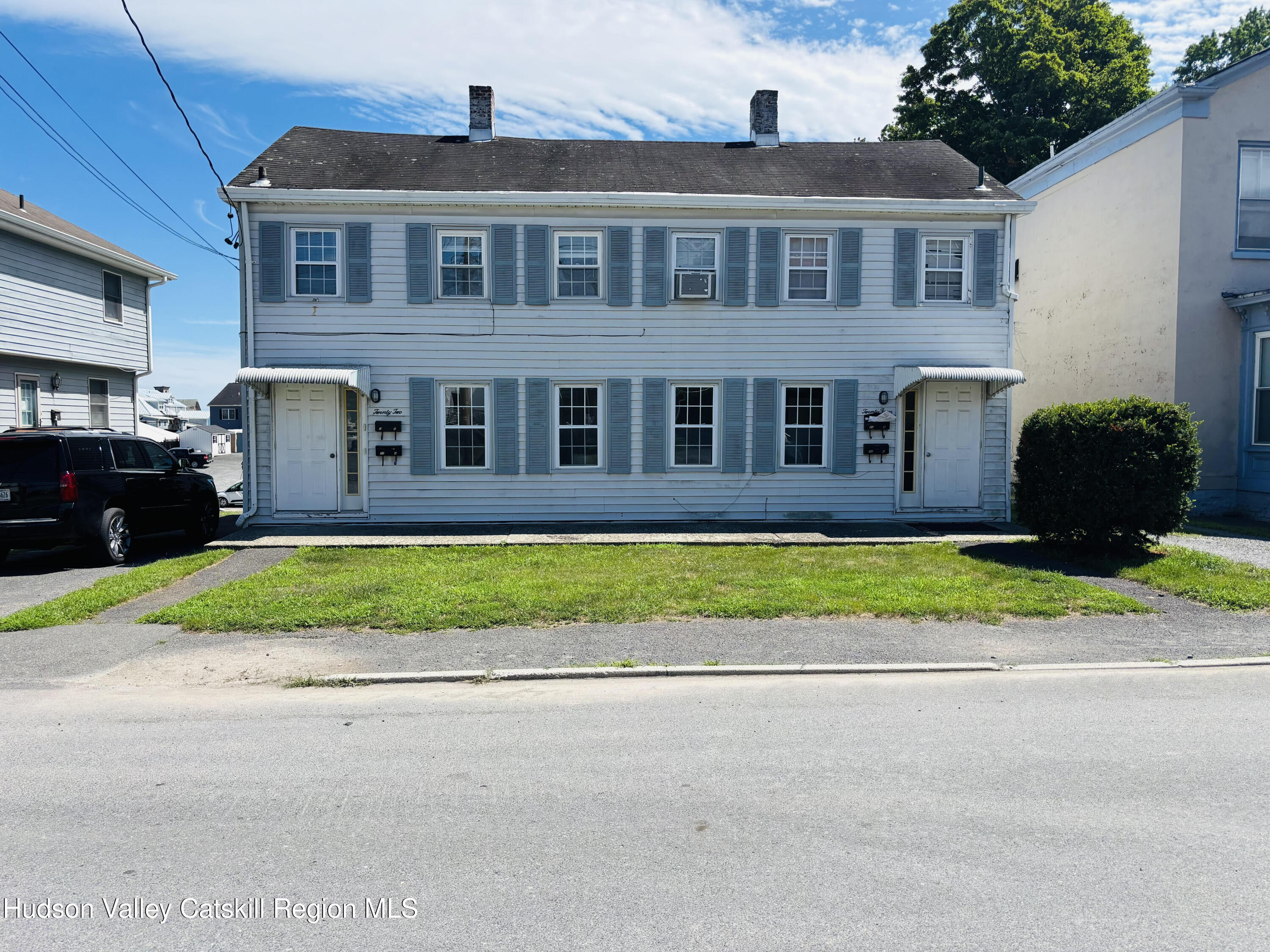 22-24 Jane Street, Unit 24A Saugerties, NY 12477 - Photo 1 of 11 a front view of a house with a yard and potted plants