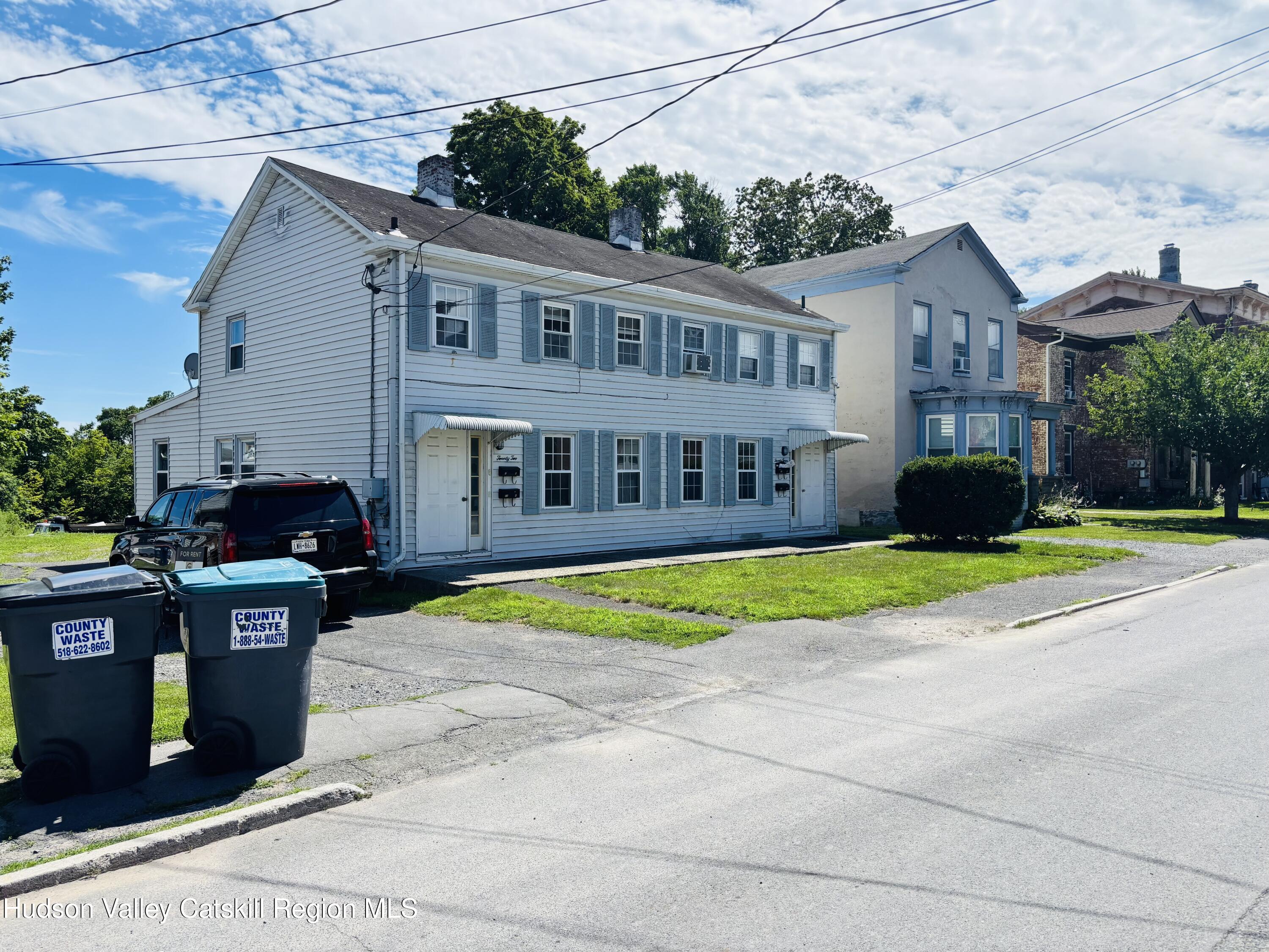22-24 Jane Street, Unit 24A Saugerties, NY 12477 - Photo 2 of 11 a front view of a house with a yard and garage