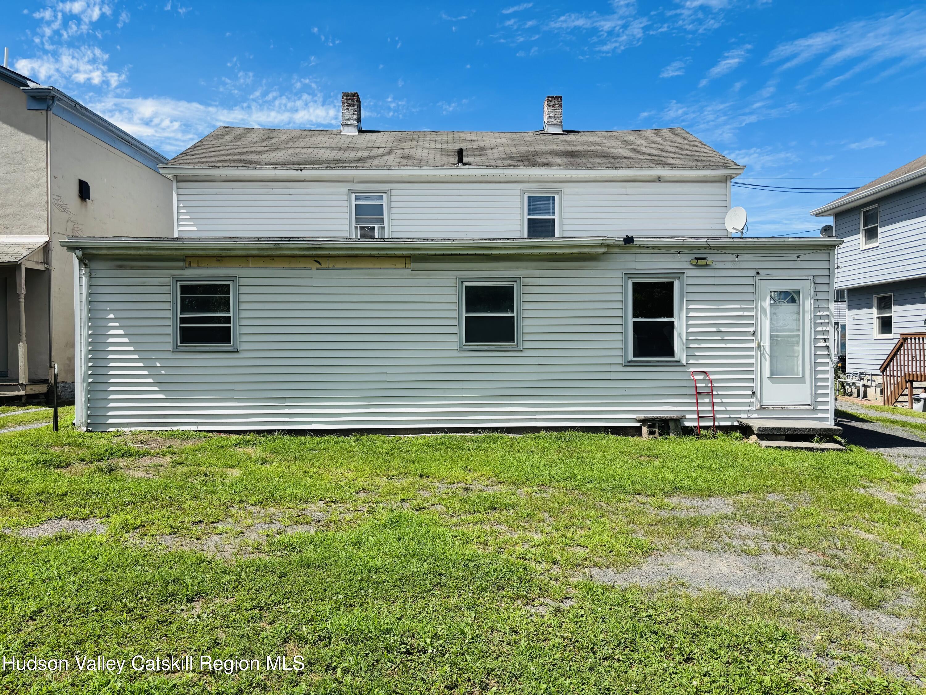 22-24 Jane Street, Unit 24A Saugerties, NY 12477 - Photo 3 of 11 a backyard of a house with table and chairs