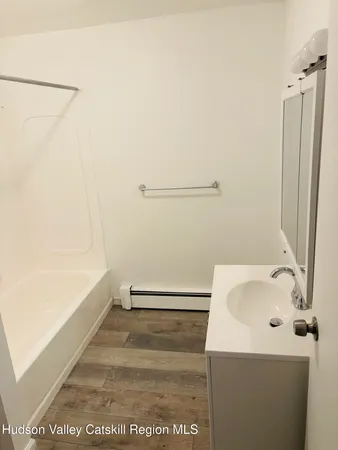 a white toilet sitting next to a shower