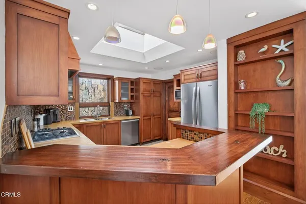 a kitchen with stainless steel appliances granite countertop a sink and cabinets