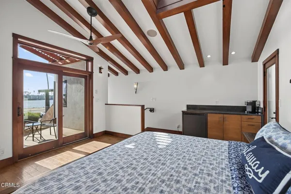 a bedroom with a bed closet and a large window