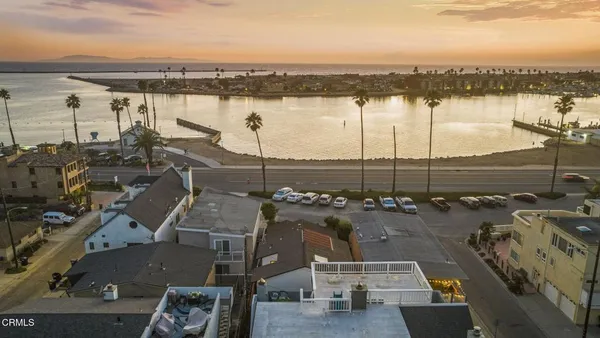 an aerial view of a residential building with outdoor space and ocean view