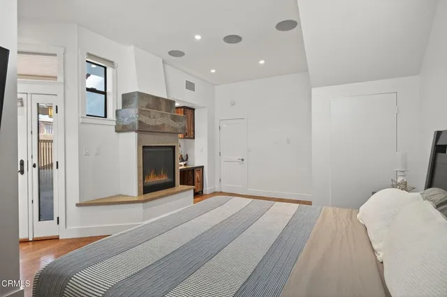 a bathroom with a granite countertop sink a mirror a bathtub and shower