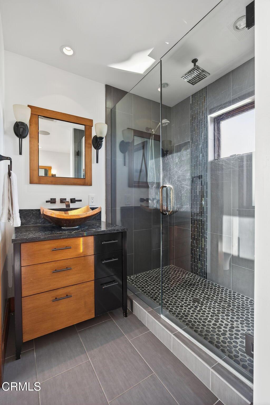 2916 Lakeshore Court Oxnard, CA 93035 - Photo 38 of 51 a bathroom with a mirror and a shower