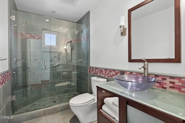 a bathroom with a toilet sink and shower