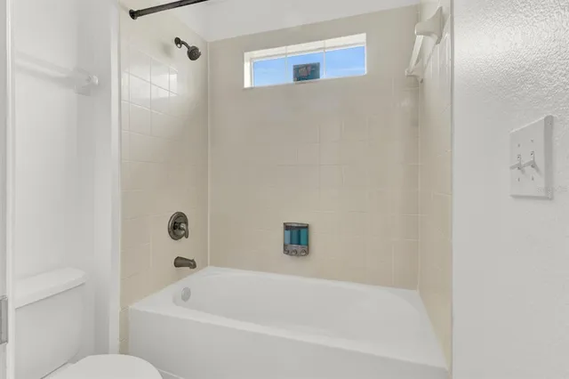 a white bath tub sitting next to a white toilet