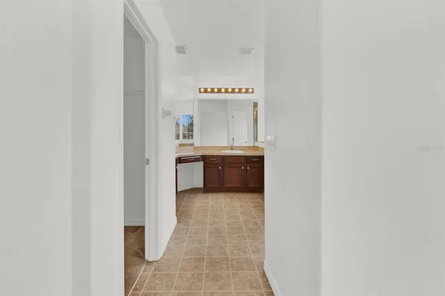 a en suite bathroom with a sink and a mirror
