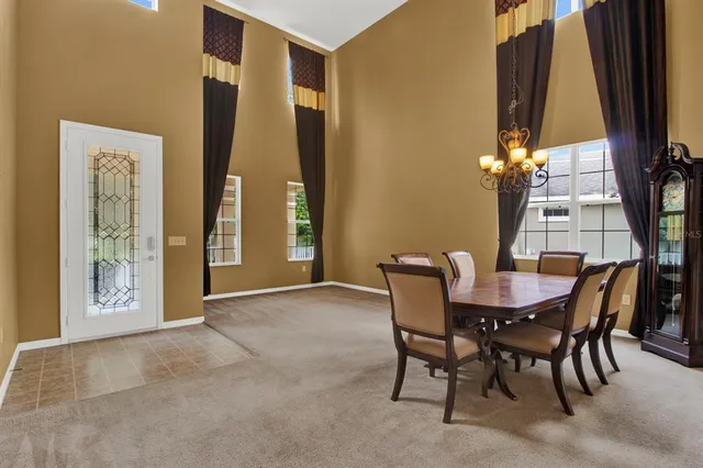 a view of a dining room with furniture and a window