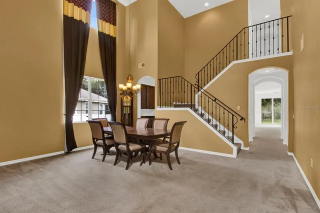 a view of a dining room with furniture and a floor to ceiling window