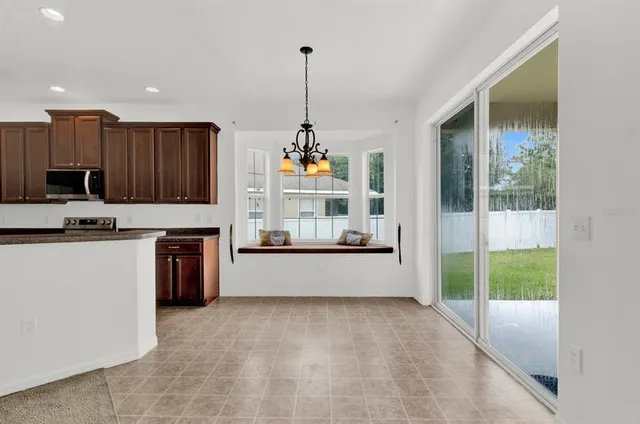 a view of a livingroom with a flat screen tv cabinets and a kitchen