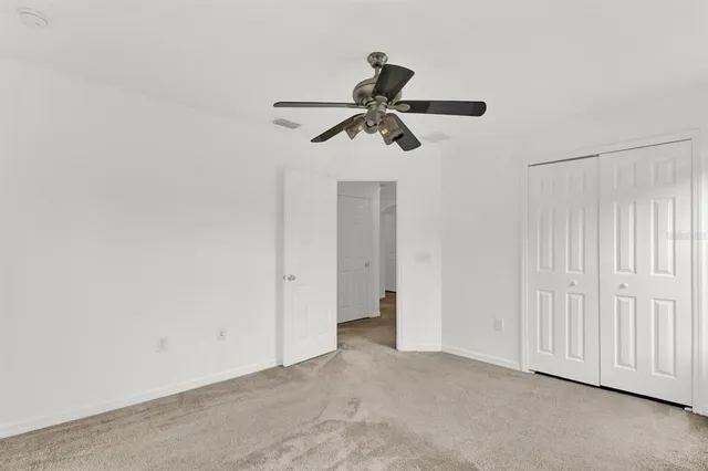 an empty room with a ceiling fan
