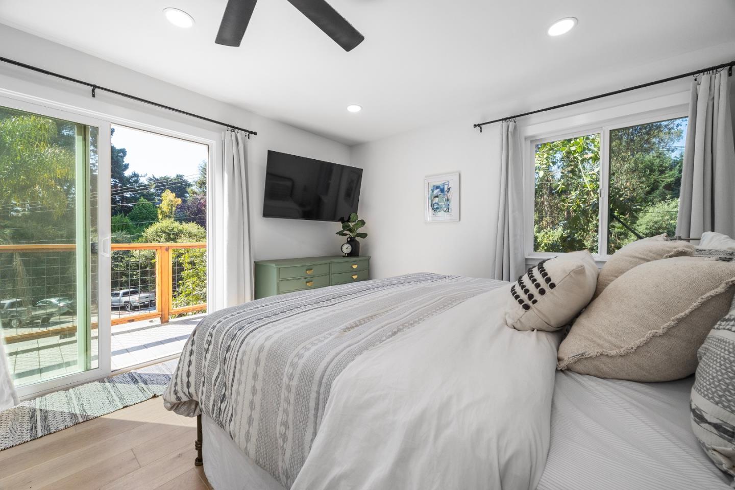 305 Sumner Avenue Aptos, CA 95003 - Photo 13 of 22 a bedroom with a bed a flat screen tv and a large window