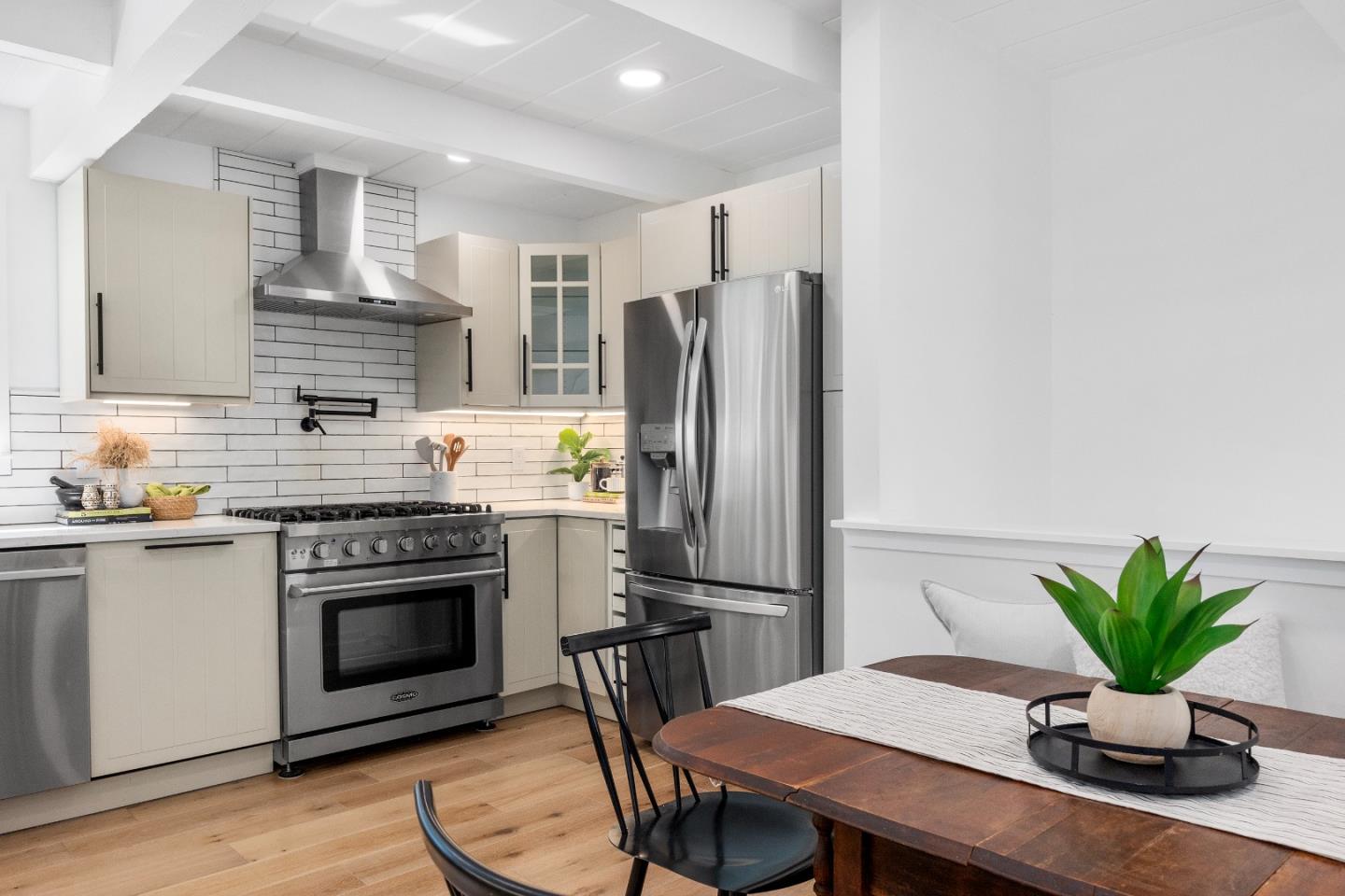 305 Sumner Avenue Aptos, CA 95003 - Photo 5 of 22 a kitchen with a wooden floor and a refrigerator