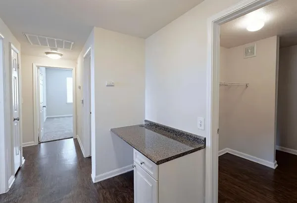 a view of a hallway with wooden floor