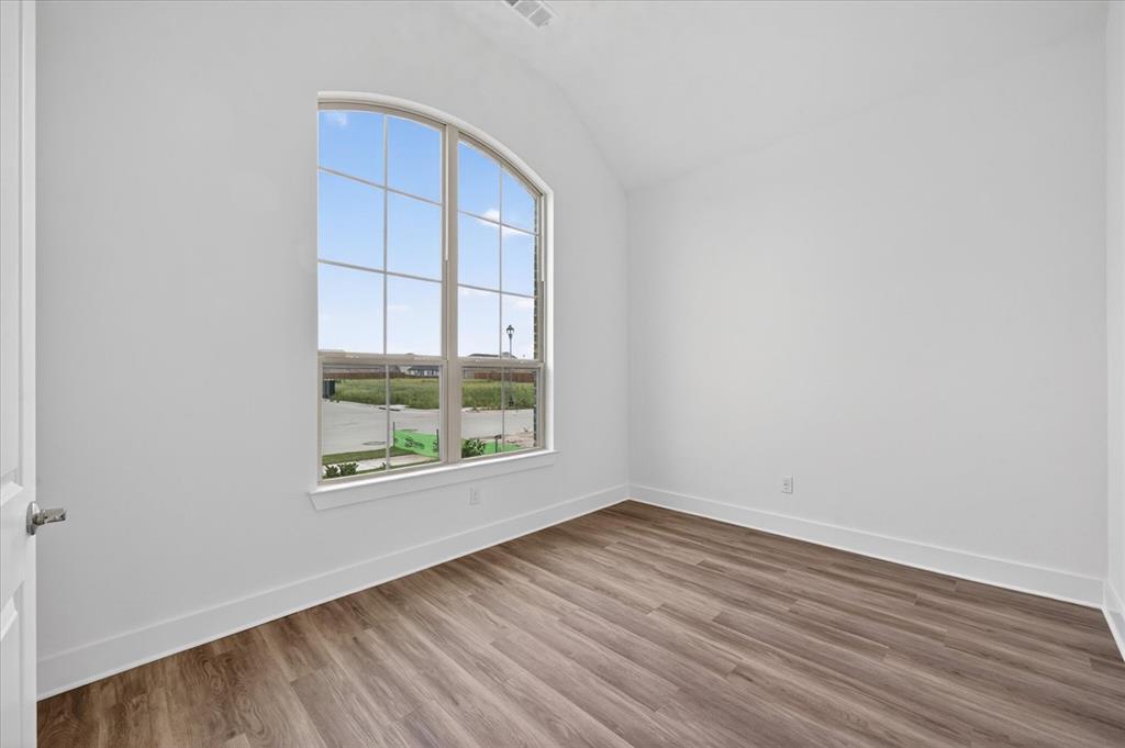1629 Buscot Lane Fort Worth, TX 76052 - Photo 18 of 26 an empty room with wooden floor and windows