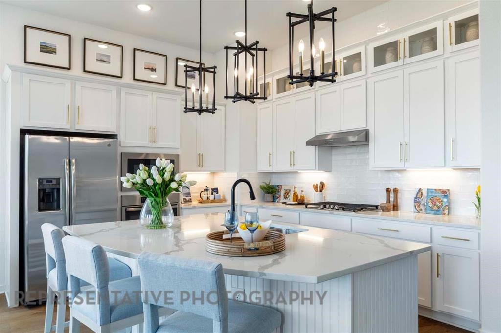 1629 Buscot Lane Haslet, TX 76052 - Photo 2 of 40 a kitchen with stainless steel appliances a sink and cabinets