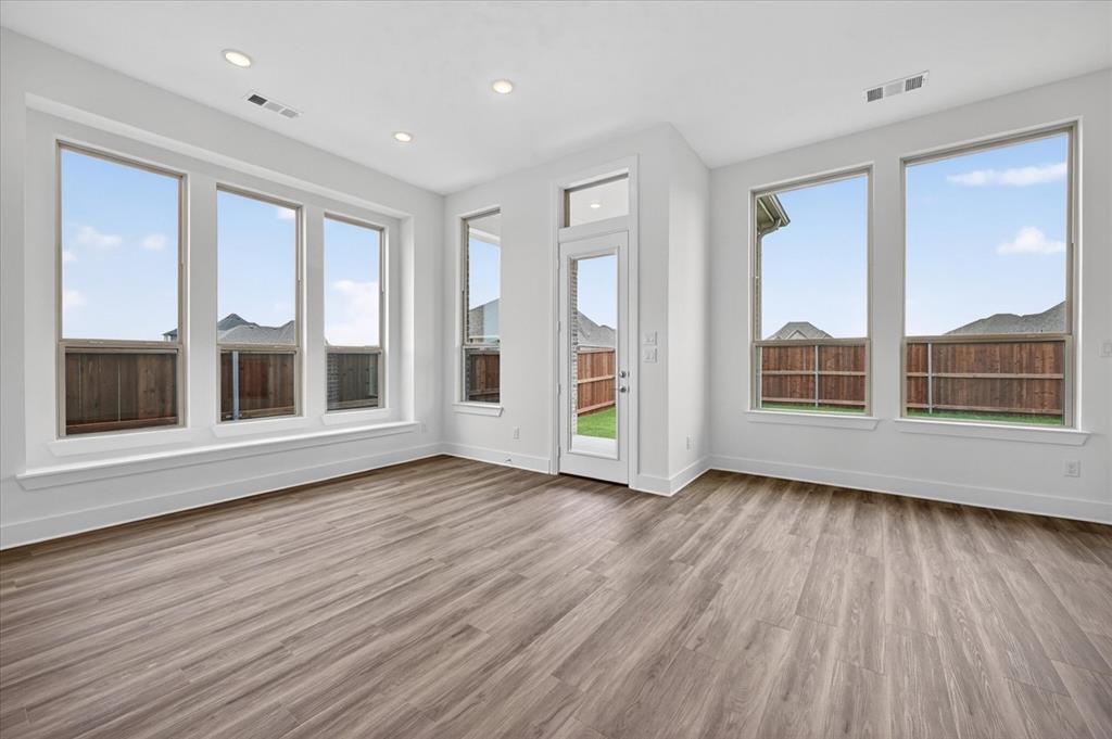 1629 Buscot Lane Fort Worth, TX 76052 - Photo 21 of 26 a view of an empty room with wooden floor and windows