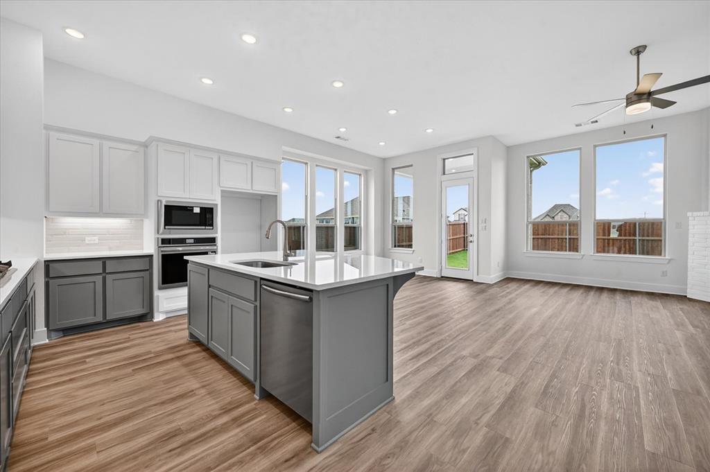 1629 Buscot Lane Fort Worth, TX 76052 - Photo 6 of 26 a kitchen with stainless steel appliances granite countertop a stove and a sink