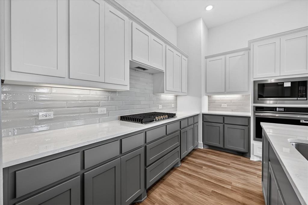 1629 Buscot Lane Fort Worth, TX 76052 - Photo 7 of 26 a kitchen with granite countertop a sink stainless steel appliances and cabinets