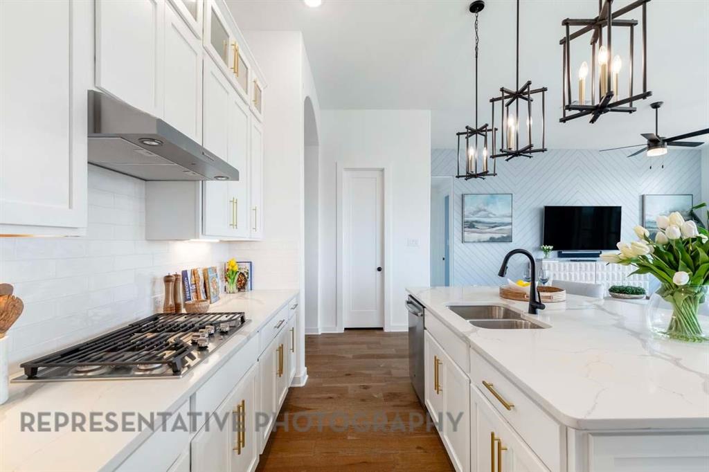 1629 Buscot Lane Haslet, TX 76052 - Photo 8 of 40 a kitchen with stainless steel appliances a sink stove and cabinets