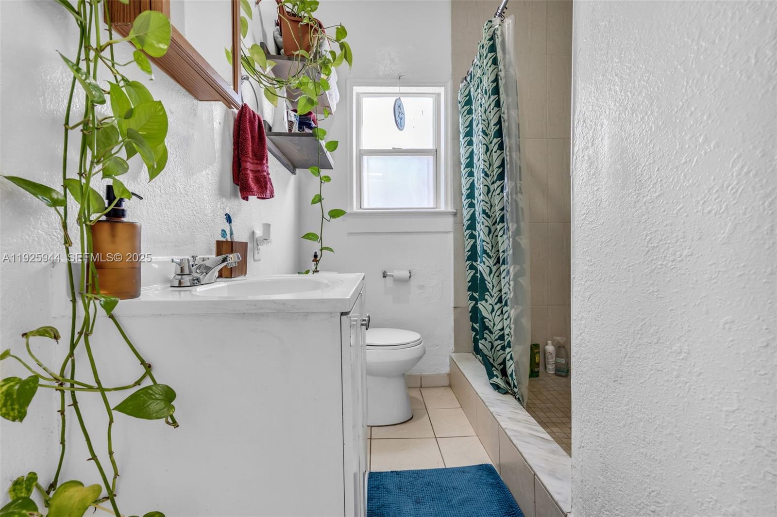 2271 Southwest 11th Street Miami, FL 33135 - Photo 11 of 17 a bathroom with a sink a toilet and a mirror