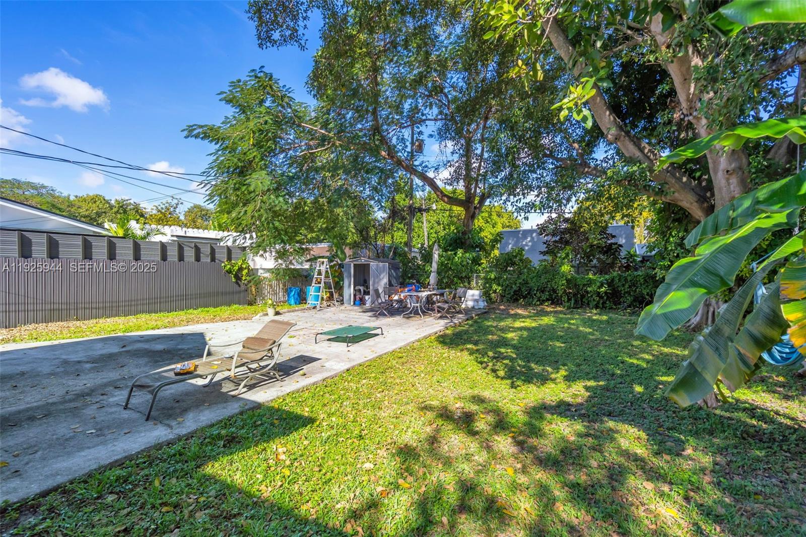 2271 Southwest 11th Street Miami, FL 33135 - Photo 13 of 17 a view of a swimming pool with lawn chairs under an umbrella
