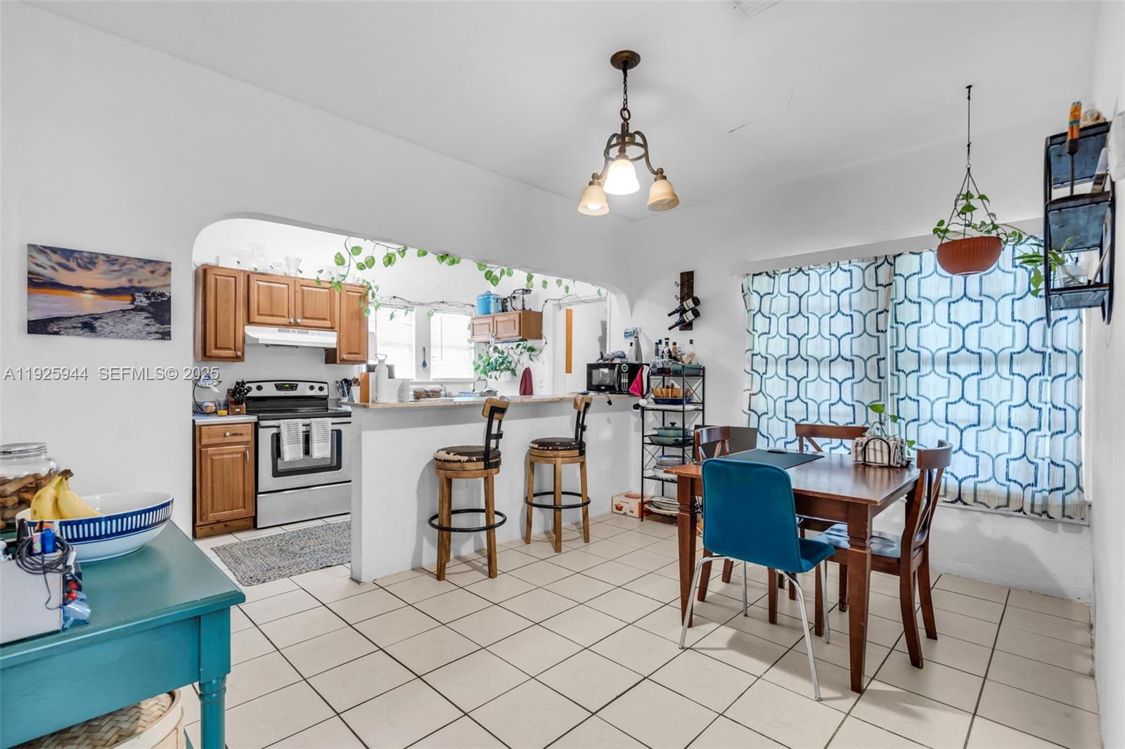 2271 Southwest 11th Street Miami, FL 33135 - Photo 6 of 17 a kitchen with a dining table chairs and white appliances