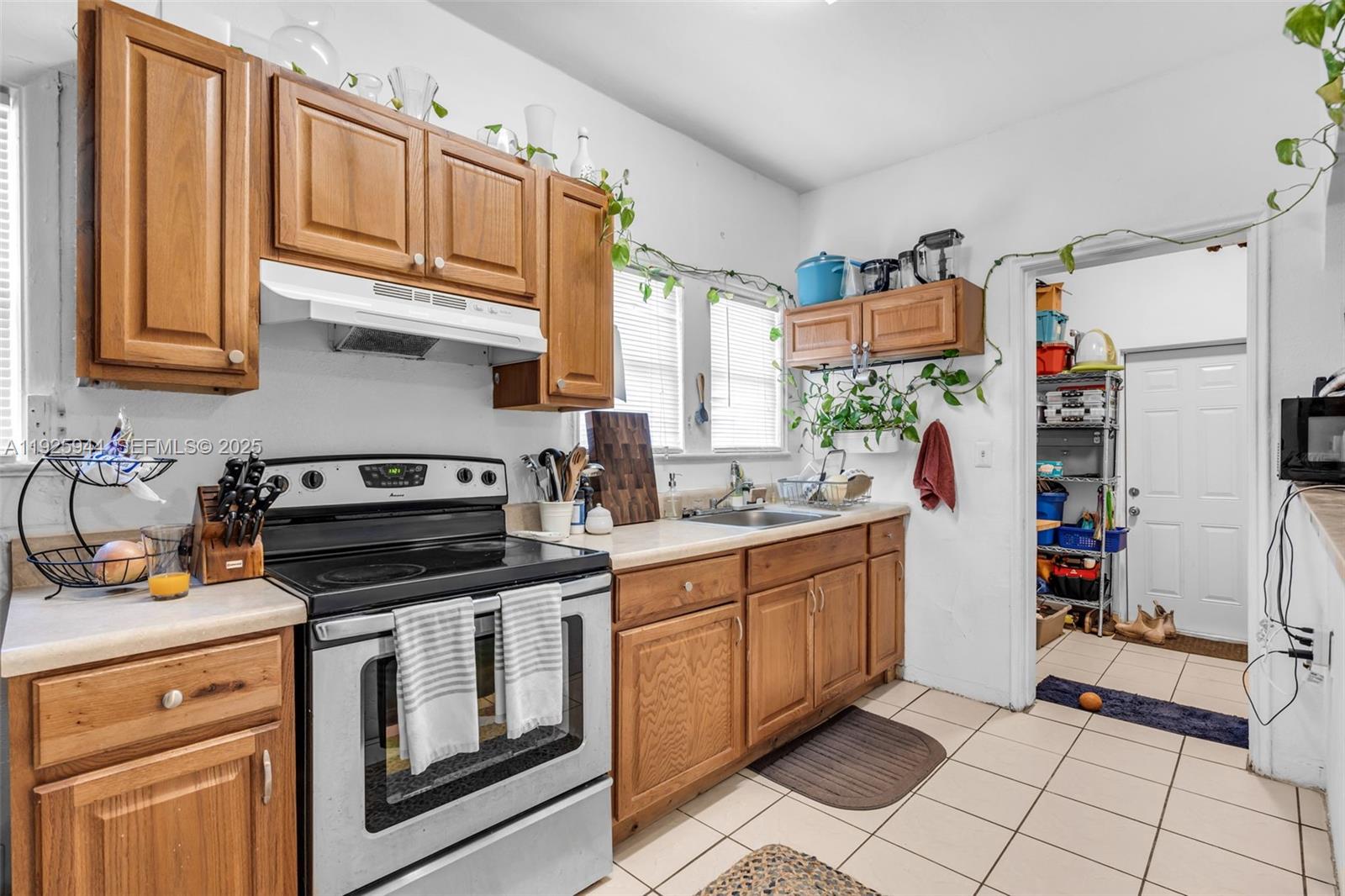 2271 Southwest 11th Street Miami, FL 33135 - Photo 7 of 17 a kitchen with stainless steel appliances granite countertop a stove a sink and a refrigerator