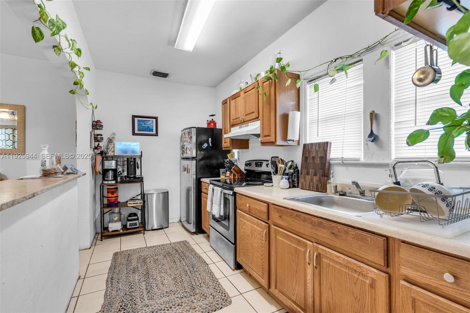 2271 Southwest 11th Street Miami, FL 33135 - Photo 8 of 17 a kitchen with sink cabinets and appliances