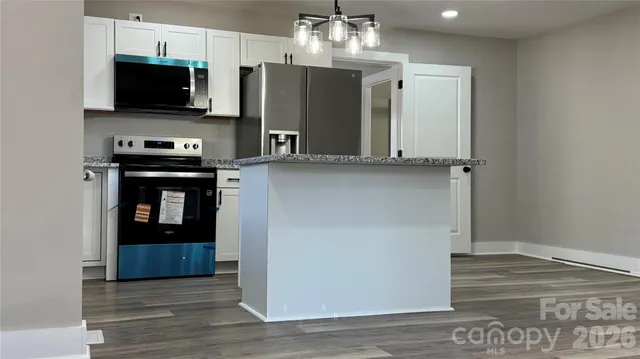 a kitchen with stainless steel appliances a stove microwave and a refrigerator