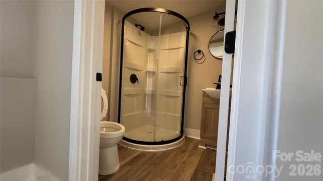 a bathroom with a glass shower door