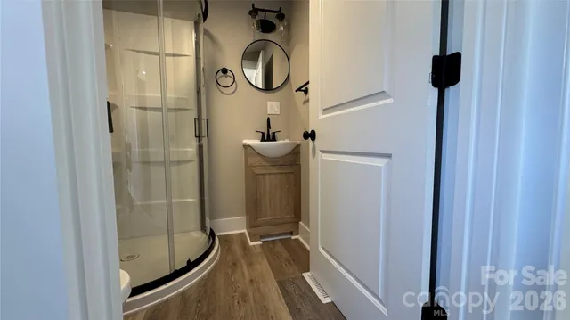 a bathroom with a mirror and a shower