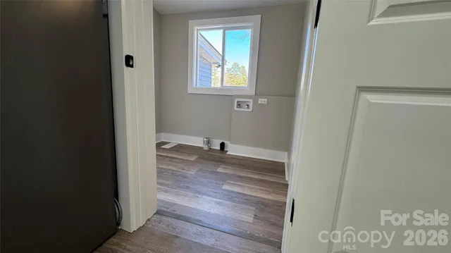 a view of a livingroom with wooden floor and a window