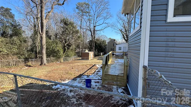 a view of a patio with two couches next to a yard