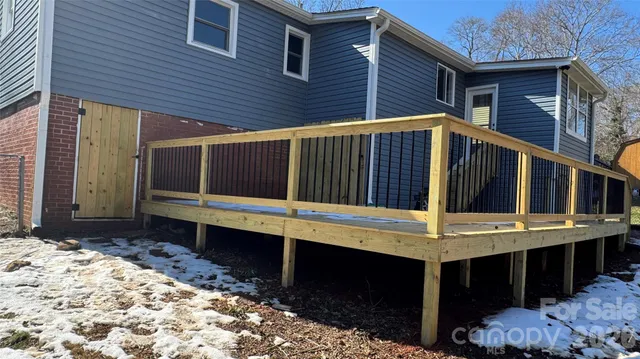 a view of a house with a wooden deck