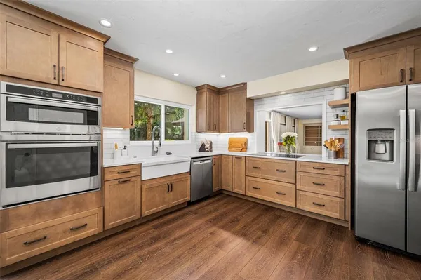 a spacious bedroom with a large bed and a chandelier