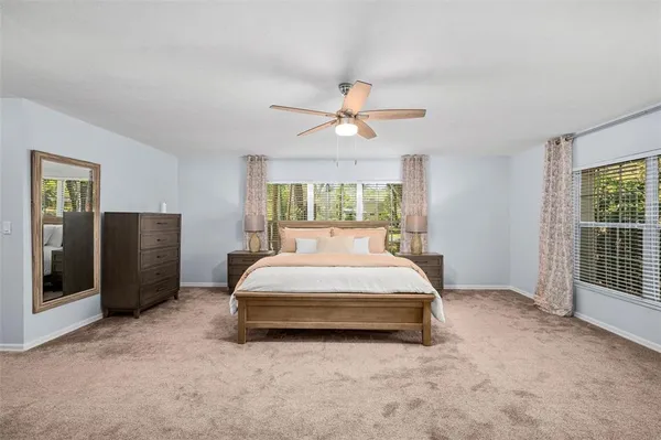 a bathroom with a granite countertop sink a mirror and a shower