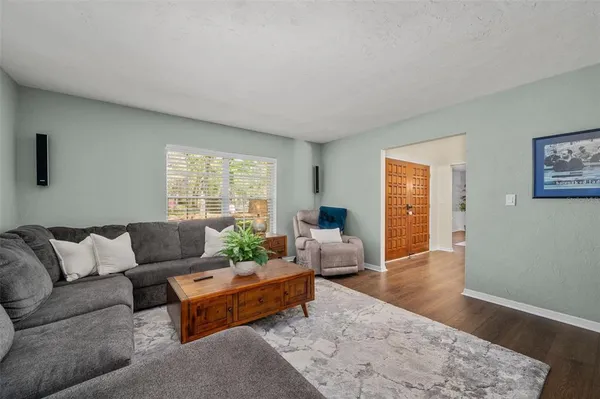 a dining room with furniture and wooden floor
