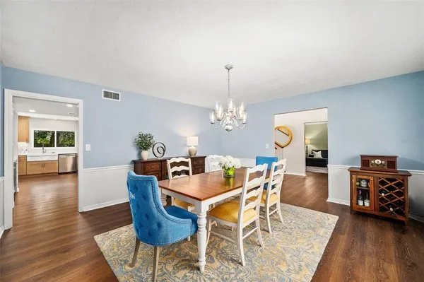 a large kitchen with stainless steel appliances kitchen island granite countertop a sink and cabinets