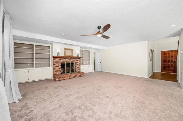 a spacious bedroom with a bed and a large window