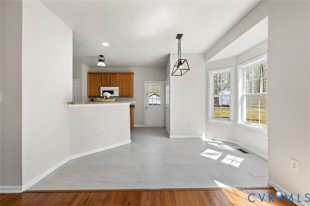 201 Washington Drive Ruther Glen, VA 22546 - Photo 11 of 27 an empty room with a window and wooden floor