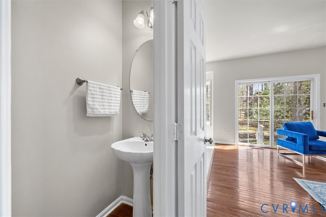 201 Washington Drive Ruther Glen, VA 22546 - Photo 14 of 27 a view of a hallway with wooden floor and a living room