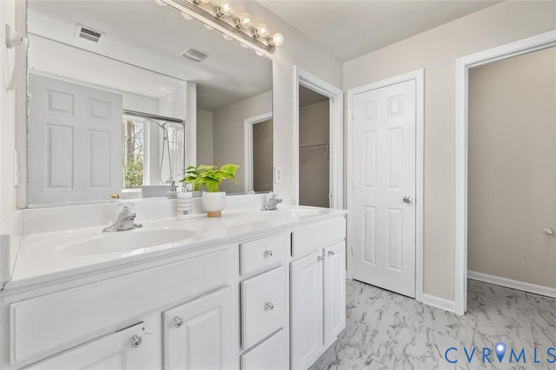 201 Washington Drive Ruther Glen, VA 22546 - Photo 17 of 27 a bathroom with a double vanity sink and a mirror