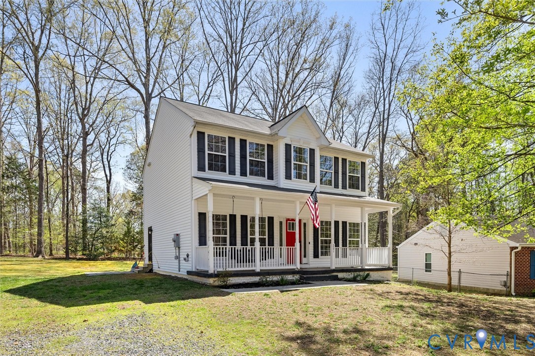 201 Washington Drive Ruther Glen, VA 22546 - Photo 2 of 27 a front view of a house with a yard