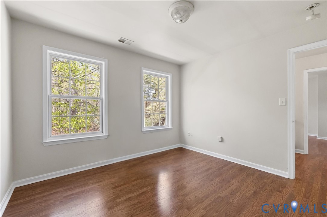 201 Washington Drive Ruther Glen, VA 22546 - Photo 24 of 27 an empty room with wooden floor and windows