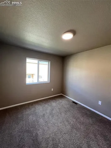 an empty room with a empty space and windows