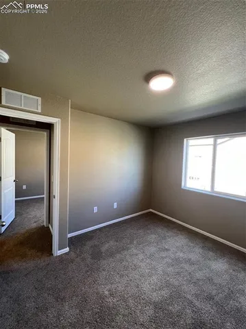 an empty room with a empty space and windows