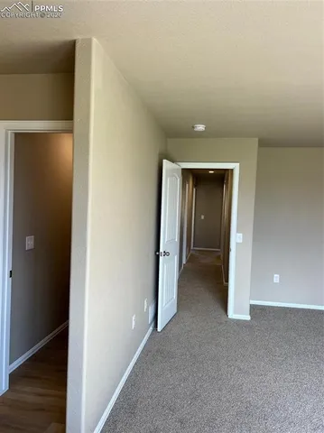 a view of hallway with wooden floor